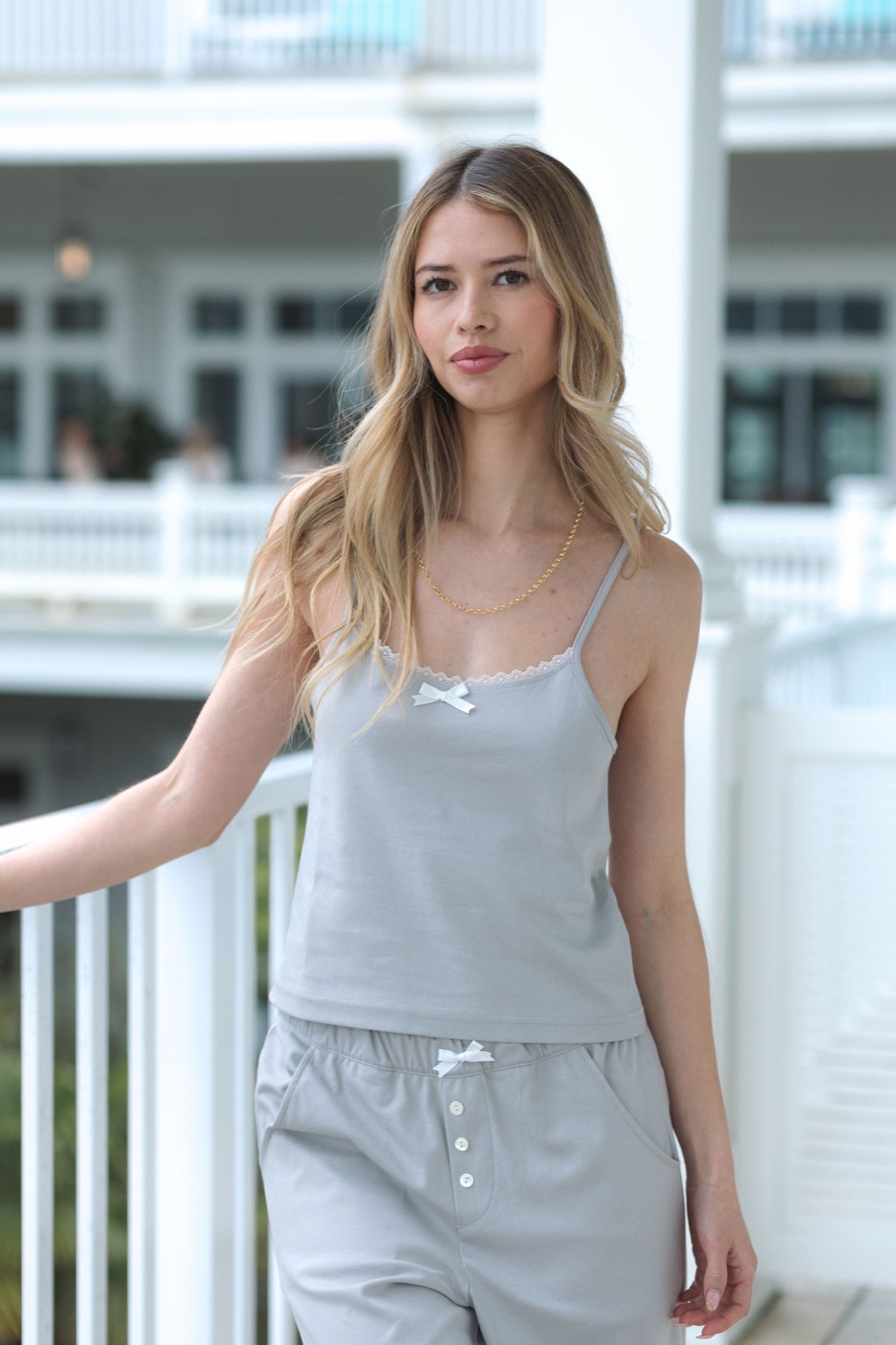 Model wearing Isla Lune grey cami and jogger set on a hotel balcony