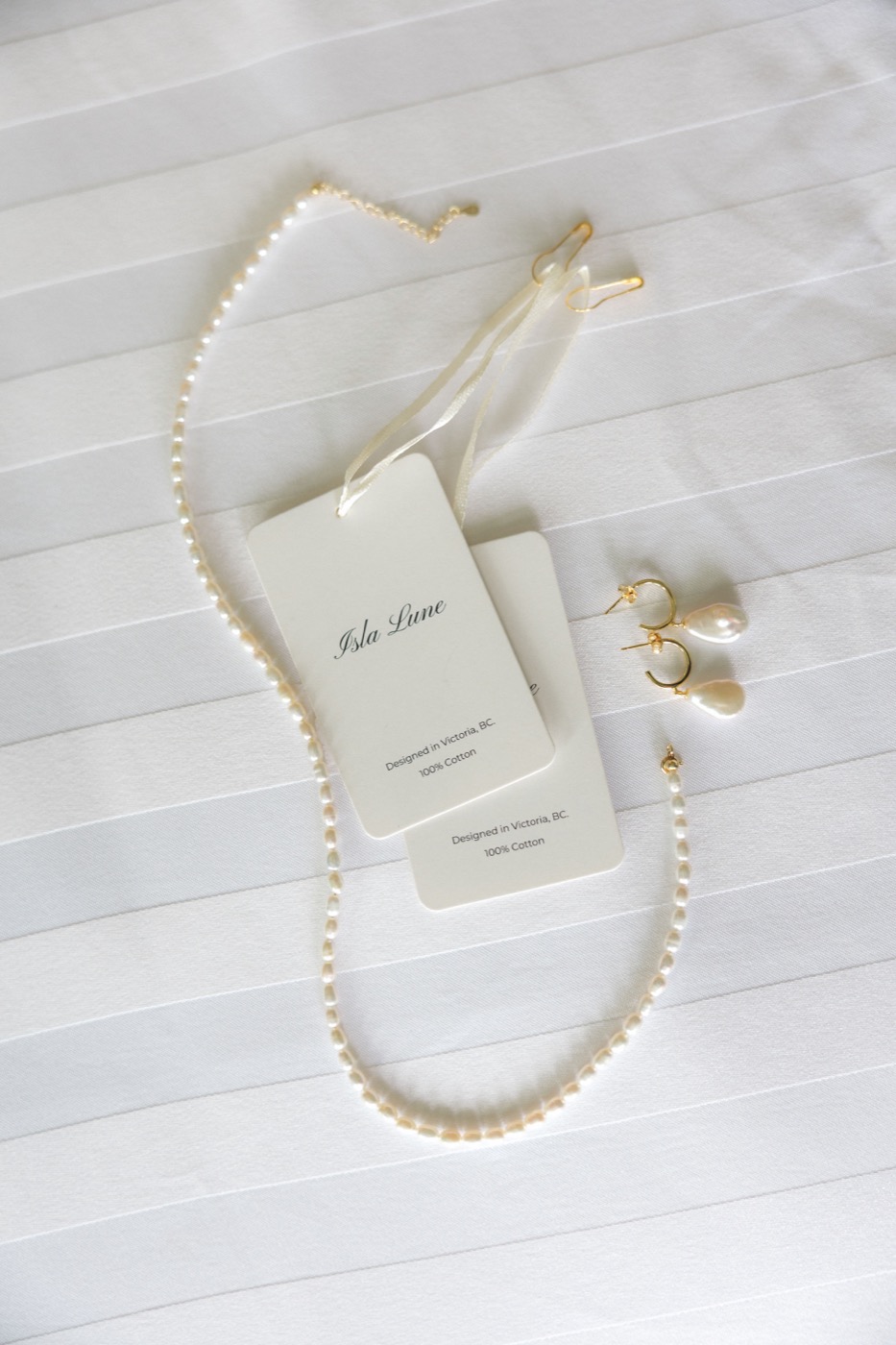 Isla Lune hangtag and pearl jewelry detail, 100% cotton, designed in Victoria BC